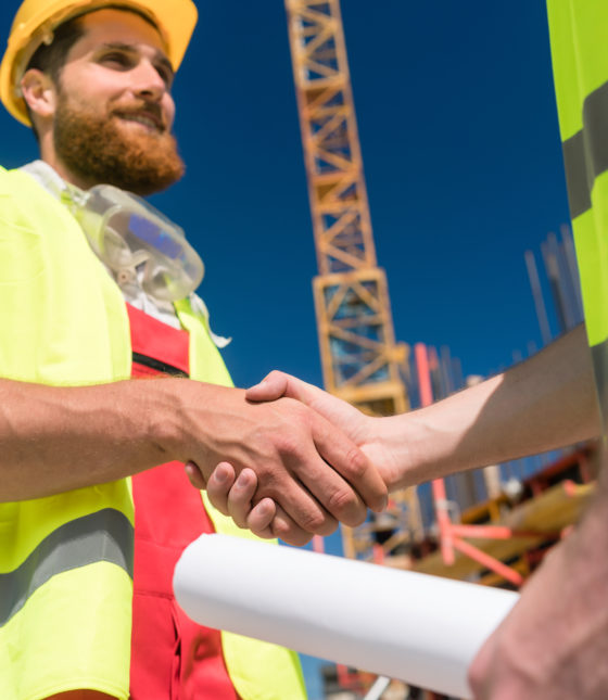 cheerful-worker-shaking-the-hand-of-an-architect-at-the-beginning-of-a-new-project