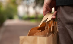 plastic free shopping concept, hand holding paper bags closeup