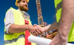 Cheerful worker shaking the hand of an architect at the beginning of a new project